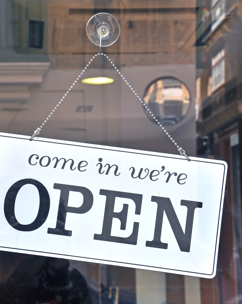open sign hangs on store door